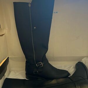 New, worn once, in box. Guess black leather riding black boots. Wide calf 7M.